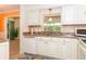 Kitchen featuring stainless steel appliances, light cabinets, and stone countertops at 72 Circlewood Dr # A2-7, Venice, FL 34293
