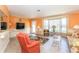 Bright living room boasting a bay window, coral walls, and comfortable seating at 72 Circlewood Dr # A2-7, Venice, FL 34293