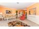 Cozy living room showcasing tile floors, comfortable seating, and a view of the dining area at 72 Circlewood Dr # A2-7, Venice, FL 34293