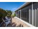 Enclosed patio featuring tile flooring, comfortable seating, and lush landscaped yard at 72 Circlewood Dr # A2-7, Venice, FL 34293