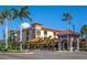 Venice Florida street view with palm trees and shops, a lively and walkable location with retail and dining at 72 Circlewood Dr # A2-7, Venice, FL 34293