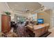 Comfortable living room featuring a ceiling fan, sliding glass doors to the patio, and plush seating at 728 Serata St, Venice, FL 34285