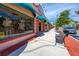 Quaint storefront with colorful awnings, window displays, and sidewalk seating at 728 Serata St, Venice, FL 34285