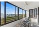 Balcony with seating offers unobstructed views of the waterfront, trees, and the city skyline in the distance at 770 S Palm Ave # 404, Sarasota, FL 34236