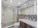 Modern bathroom featuring a glass-enclosed shower, sleek vanity, and stylish tile accents at 770 S Palm Ave # 404, Sarasota, FL 34236