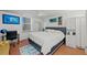 Cozy bedroom features a plush bed, tile floors, a ceiling fan, and natural light at 770 S Palm Ave # 404, Sarasota, FL 34236