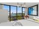Elegant dining area features an expansive window showcasing the waterfront and adjacent palm tree park at 770 S Palm Ave # 404, Sarasota, FL 34236