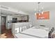 Open dining area features views into the kitchen and modern lighting at 770 S Palm Ave # 404, Sarasota, FL 34236