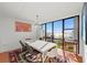 Dining room featuring water views through a large window, complemented by a stylish table set for gatherings at 770 S Palm Ave # 404, Sarasota, FL 34236
