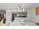 Clean dining room features contemporary lighting and views to the kitchen at 770 S Palm Ave # 404, Sarasota, FL 34236