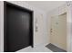 Condo elevator bank with a black elevator door and white door for unit access at 770 S Palm Ave # 404, Sarasota, FL 34236