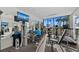 Bright fitness center with exercise equipment and large windows overlooking lush landscaping and water at 770 S Palm Ave # 404, Sarasota, FL 34236