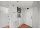 Hallway with tile flooring, neutral paint, artwork, and an access door to the unit at 770 S Palm Ave # 404, Sarasota, FL 34236