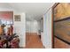 Hallway with mirror and tile flooring and decorative furniture accents that give the space depth and beauty at 770 S Palm Ave # 404, Sarasota, FL 34236