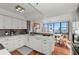 Bright kitchen featuring white cabinetry, stylish backsplash and an eat-in breakfast nook at 770 S Palm Ave # 404, Sarasota, FL 34236