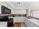 Bright modern kitchen features stylish backsplash and white cabinetry at 770 S Palm Ave # 404, Sarasota, FL 34236