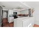 Bright kitchen featuring white cabinetry, stylish backsplash and barstool seating at 770 S Palm Ave # 404, Sarasota, FL 34236