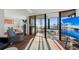 Bright living room featuring water views through sliding doors leading to the terrace at 770 S Palm Ave # 404, Sarasota, FL 34236