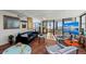 Sunlit living room with comfortable seating and floor-to-ceiling windows with water view at 770 S Palm Ave # 404, Sarasota, FL 34236