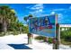 Charming sign marking Siesta Beach, #1 beach in the USA, with lush vegetation surrounding it at 770 S Palm Ave # 404, Sarasota, FL 34236