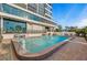 Attractive in-ground pool surrounded by a brick patio and an upscale building, offering a serene setting at 770 S Palm Ave # 404, Sarasota, FL 34236
