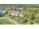 Exterior shot of a well-maintained residential building near a golf course and walking path amidst lush landscaping at 809 Montrose Dr # 203, Venice, FL 34293