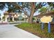 Street view of commercial buildings with dining, landscaping and signage for Centennial Park nearby at 809 Montrose Dr # 203, Venice, FL 34293