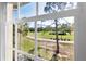 A window view overlooking a golf course and lush green scenery at 809 Montrose Dr # 203, Venice, FL 34293