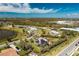 Aerial view of a neighborhood with mature landscaping, lakes, and attractive single-Gathering homes at 8170 Casa De Meadows Dr, Englewood, FL 34224