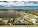 Breathtaking aerial view of homes, lake, and verdant landscapes, and community at 8170 Casa De Meadows Dr, Englewood, FL 34224