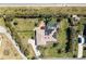 Aerial view of a beautiful property featuring a private pool and solar panels at 8170 Casa De Meadows Dr, Englewood, FL 34224