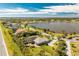 Waterfront property with a pool, solar panels and lush landscaping overlooking a serene lake at 8170 Casa De Meadows Dr, Englewood, FL 34224