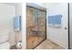 Bathroom with a glass enclosed shower, tiled flooring, and decorative towels at 8170 Casa De Meadows Dr, Englewood, FL 34224