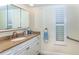 Bathroom with a granite countertop, ample storage, and plantation shutters at 8170 Casa De Meadows Dr, Englewood, FL 34224