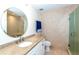 Bathroom with a large mirror, tiled walk-in shower, and tiled flooring at 8170 Casa De Meadows Dr, Englewood, FL 34224