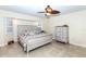 Well-lit bedroom features a ceiling fan, neutral walls, and light-colored floors at 8170 Casa De Meadows Dr, Englewood, FL 34224