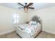 Bedroom with a ceiling fan, plantation shutters, and tiled flooring at 8170 Casa De Meadows Dr, Englewood, FL 34224