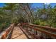Elevated wooden boardwalk surrounded by lush trees and foliage, perfect for scenic nature walks and exploration at 8170 Casa De Meadows Dr, Englewood, FL 34224