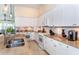 Close up view of modern kitchen with granite countertops and white cabinets at 8170 Casa De Meadows Dr, Englewood, FL 34224