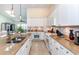 Updated kitchen featuring white cabinets, granite countertops, and modern appliances at 8170 Casa De Meadows Dr, Englewood, FL 34224