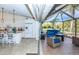 Open kitchen that extends to a screened lanai with patio furniture at 8170 Casa De Meadows Dr, Englewood, FL 34224