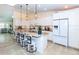 Modern kitchen with granite counters, white cabinets, stainless steel appliances, and breakfast bar at 8170 Casa De Meadows Dr, Englewood, FL 34224