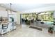 Spacious kitchen opens to a screened patio and outdoor living space at 8170 Casa De Meadows Dr, Englewood, FL 34224
