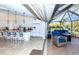 Bright kitchen leading to screened-in patio featuring outdoor seating area at 8170 Casa De Meadows Dr, Englewood, FL 34224