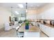 Open concept kitchen with stainless steel appliances, granite counters, breakfast bar, and adjoining dining area at 8170 Casa De Meadows Dr, Englewood, FL 34224