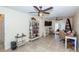 Living room with a ceiling fan, built-in bookshelf, and tiled flooring at 8170 Casa De Meadows Dr, Englewood, FL 34224