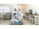 Cozy living room featuring tile floors, a plush sofa, and charming coastal-themed decor at 8170 Casa De Meadows Dr, Englewood, FL 34224