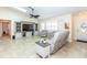 Inviting living area featuring tile flooring, a ceiling fan, and ample natural light at 8170 Casa De Meadows Dr, Englewood, FL 34224