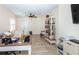 Living room with a ceiling fan, built-in bookshelf, and tiled flooring at 8170 Casa De Meadows Dr, Englewood, FL 34224