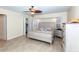 Spacious main bedroom with a ceiling fan, walk-in closet, and tiled flooring at 8170 Casa De Meadows Dr, Englewood, FL 34224